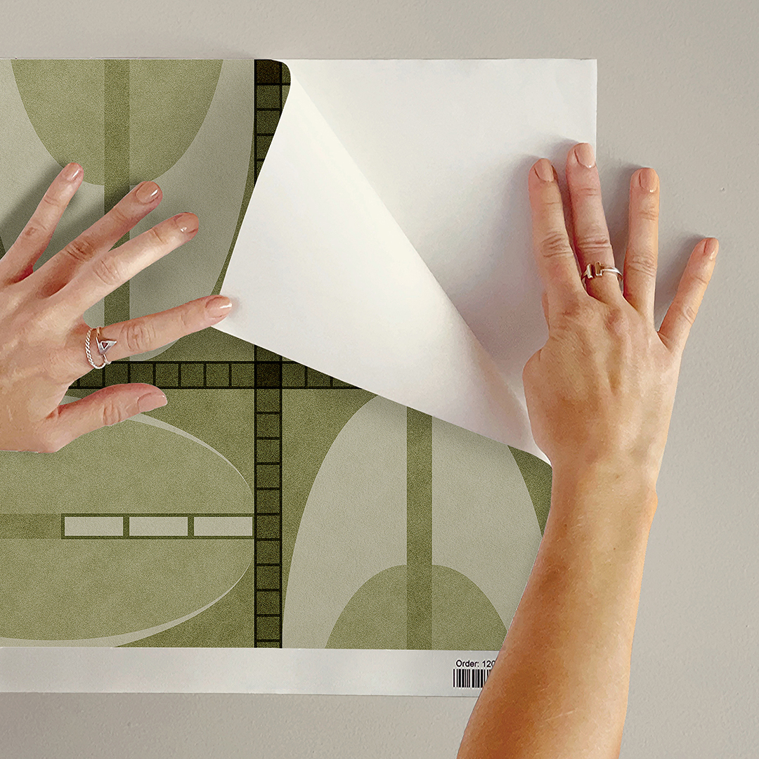 The artwork features a repeating geometric pattern of symmetrical shapes resembling elongated, curved diamonds or petals in various shades of blue and green. Each shape is split vertically with one half filled with a light blue and the other half filled with green or darker blue. The background is a light, almost pastel blue, which provides a soft yet vibrant backdrop. One of the blue shapes near the upper left contains a white starburst element, adding a focal point of brightness to the composition. The overall design conveys a modern, mid-century aesthetic with clean lines and harmonious color contrasts.